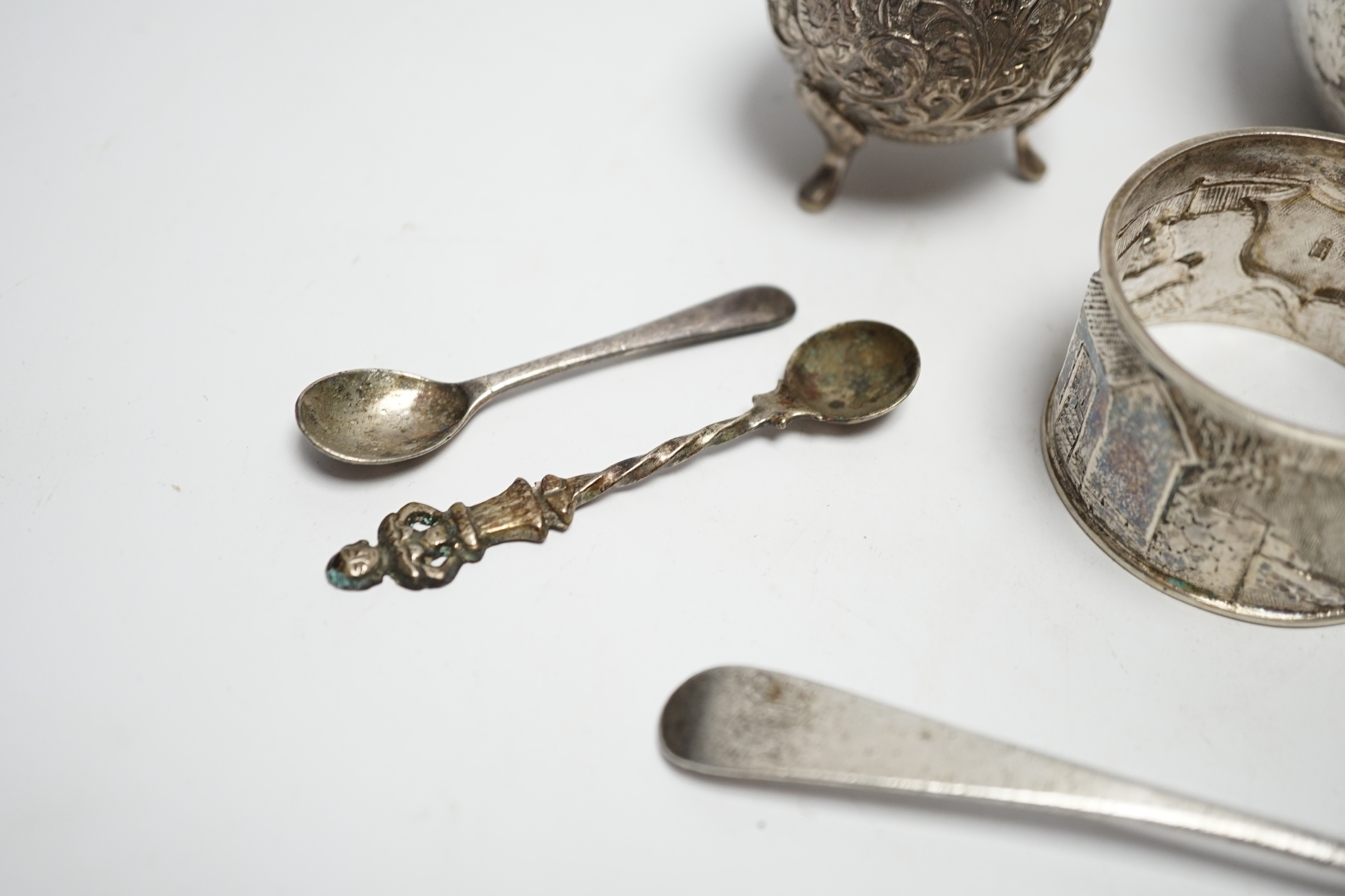 A Thai white metal bowl, diameter 82mm, a Chinese white metal napkin ring, a white metal three piece cruet set and four assorted spoons including George IV teaspoon by William Bateman.